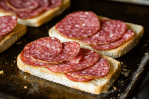Layering salami on sandwich bread
